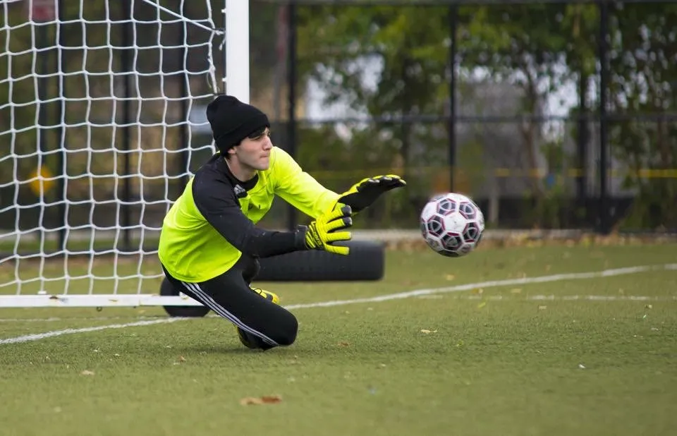 Sasha diving to make a save as a high school goalie
